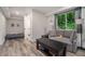 Cozy basement with gray wood floors, couch and daybed at 507 Spring Creek Ne Way, Marietta, GA 30068