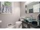 Chic half-bathroom with a glass vessel sink, stylish vanity, and elegant fixtures at 507 Spring Creek Ne Way, Marietta, GA 30068