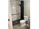 Well-lit bathroom featuring a walk-in shower with marble paneling and a handheld shower at 507 Spring Creek Ne Way, Marietta, GA 30068