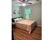 Cozy bedroom featuring hardwood floors, a ceiling fan, and natural light from the window at 507 Spring Creek Ne Way, Marietta, GA 30068