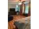Bright bedroom with a ceiling fan, hardwood floors, and built-in wooden storage at 507 Spring Creek Ne Way, Marietta, GA 30068