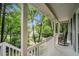 Relaxing covered porch with rocking chairs and views of a lush, green neighborhood at 507 Spring Creek Ne Way, Marietta, GA 30068