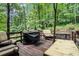 Back deck with chairs, grill, and lush green scenery at 507 Spring Creek Ne Way, Marietta, GA 30068