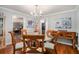 Bright dining room with hardwood floors, a round glass table, and neutral decor at 507 Spring Creek Ne Way, Marietta, GA 30068