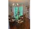 Elegant dining room with a glass table, chandelier, and wood floors, creating a perfect setting for meals at 507 Spring Creek Ne Way, Marietta, GA 30068