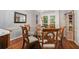 Elegant dining room with hardwood floors and a glass-topped table with wooden chairs at 507 Spring Creek Ne Way, Marietta, GA 30068