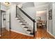 Inviting entryway with hardwood floors and a staircase with a black railing and gray carpet at 507 Spring Creek Ne Way, Marietta, GA 30068