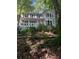 Charming two-story home with a welcoming front porch, surrounded by lush greenery and mature trees at 507 Spring Creek Ne Way, Marietta, GA 30068