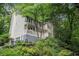 Charming two-story home with a covered front porch nestled among mature trees and lush landscaping at 507 Spring Creek Ne Way, Marietta, GA 30068