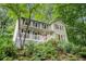 Inviting two-story home with a white porch and stairs surrounded by lush greenery at 507 Spring Creek Ne Way, Marietta, GA 30068