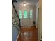 Warm and inviting foyer featuring hardwood floors, a staircase, and a bright, welcoming entryway at 507 Spring Creek Ne Way, Marietta, GA 30068
