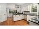 Well-lit kitchen with hardwood floors, white cabinets, and stainless steel appliances at 507 Spring Creek Ne Way, Marietta, GA 30068