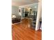 Open-concept living room with hardwood floors, built-in shelving, a cozy fireplace, and ample natural light at 507 Spring Creek Ne Way, Marietta, GA 30068