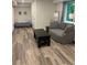Finished basement area with couch, futon, coffee table, window, and modern flooring at 507 Spring Creek Ne Way, Marietta, GA 30068
