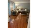 Spacious living room featuring gleaming hardwood floors and a comfortable sectional sofa at 507 Spring Creek Ne Way, Marietta, GA 30068