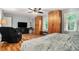 Inviting main bedroom featuring built-in wardrobe cabinets and a cozy recliner at 507 Spring Creek Ne Way, Marietta, GA 30068