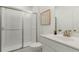 Clean bathroom with white vanity, glass enclosed shower, and square tile floor at 1088 Battery Park Rd, Decatur, GA 30033