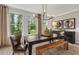 Stylish dining room boasts large windows, modern lighting, and wood accents at 1088 Battery Park Rd, Decatur, GA 30033