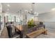 Open kitchen and dining area featuring stainless appliances, a large island with seating, and modern lighting at 1088 Battery Park Rd, Decatur, GA 30033