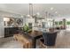 Open kitchen and dining area with stainless steel appliances, a large island and modern lighting fixtures at 1088 Battery Park Rd, Decatur, GA 30033