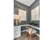 Dedicated office nook featuring a built-in desk, modern chair, and gray walls adorned with contemporary artwork at 1088 Battery Park Rd, Decatur, GA 30033
