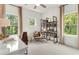 Bright office with lots of light from the windows, a desk and chair, and shelving at 1088 Battery Park Rd, Decatur, GA 30033