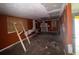 Spacious living room awaiting renovation, featuring boarded windows and original architectural details at 1101 Isa Se Dr, Atlanta, GA 30315