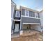 Gray townhome under construction featuring an attached garage and white trim at 216 Seward St # 93, Conyers, GA 30094