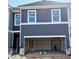 New construction townhome featuring a garage and modern gray siding at 216 Seward St # 93, Conyers, GA 30094