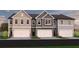 Row of new townhomes showcasing a variety of siding colors and garage doors at 216 Seward St # 93, Conyers, GA 30094
