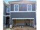 New construction townhome featuring a garage and modern gray siding at 216 Seward St # 93, Conyers, GA 30094