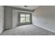 Spacious carpeted bedroom with bright window and neutral color palette at 3187 Mill Springs Cir, Buford, GA 30519