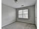 Neutral bedroom featuring soft carpet, window with blinds, and fresh paint ready for personal touches at 3187 Mill Springs Cir, Buford, GA 30519