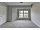 Spacious carpeted bedroom with bright window and neutral color palette at 3187 Mill Springs Cir, Buford, GA 30519