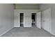 Neutral bedroom featuring plush carpeting, bathroom, and ample closet space at 3187 Mill Springs Cir, Buford, GA 30519