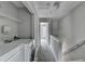 Well-lit hallway includes laundry area with modern washer and dryer at 3187 Mill Springs Cir, Buford, GA 30519