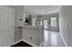 A view of the kitchen with tile floors, a breakfast bar, and white cabinets at 3187 Mill Springs Cir, Buford, GA 30519
