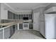 Kitchen with gray cabinets, stainless steel appliances, tile floor and white countertops at 3187 Mill Springs Cir, Buford, GA 30519