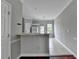 A view of the kitchen with tile floors, a breakfast bar, and white cabinets at 3187 Mill Springs Cir, Buford, GA 30519