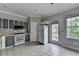 The kitchen features gray cabinets, white appliances and a view to the deck at 3187 Mill Springs Cir, Buford, GA 30519