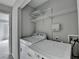 Bright laundry area with modern washer and dryer and wire shelving at 3187 Mill Springs Cir, Buford, GA 30519