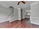 Bright living area with hardwood floors, neutral paint, and staircase at 3187 Mill Springs Cir, Buford, GA 30519