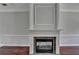 Living room with a fireplace and gray walls, plus white trim and dark hardwood floors at 3187 Mill Springs Cir, Buford, GA 30519