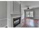 Living room showing hardwood floors, a fireplace with stone surround and large window at 3187 Mill Springs Cir, Buford, GA 30519