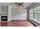 Living room features hardwood floors, fireplace with mantle and large window at 3187 Mill Springs Cir, Buford, GA 30519
