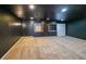 Finished basement with tan carpeting and black walls, creating a modern aesthetic at 5280 Lakerock Way, South Fulton, GA 30331