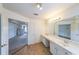 Bright bathroom featuring a dual sink vanity with a large mirror at 5280 Lakerock Way, South Fulton, GA 30331