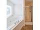 Bright bathroom showcasing the soaking tub and shower with tiled floor at 5280 Lakerock Way, South Fulton, GA 30331