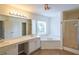 Bright bathroom featuring a shower, soaking tub, dual sink vanity and large mirror at 5280 Lakerock Way, South Fulton, GA 30331