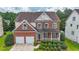 Beautiful two-story brick home featuring well-maintained landscaping and a welcoming covered front porch at 5280 Lakerock Way, South Fulton, GA 30331